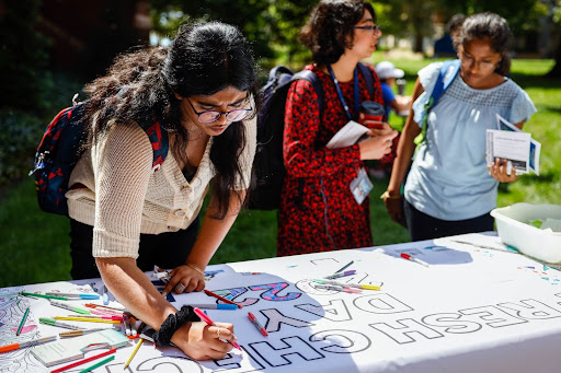 Students signing a banner