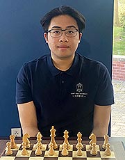 Ralph Tan Ralph Tan poses for a photo while sitting in front of a chess board