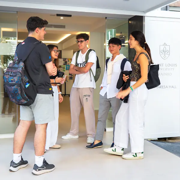 SLU students stand and mingle near the gateway of the SLU-Madrid campus.
