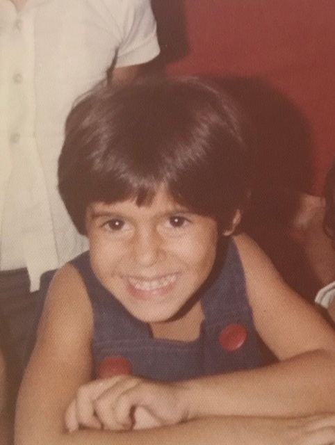 Alameh as a child Alameh as a child, posing with a smile.