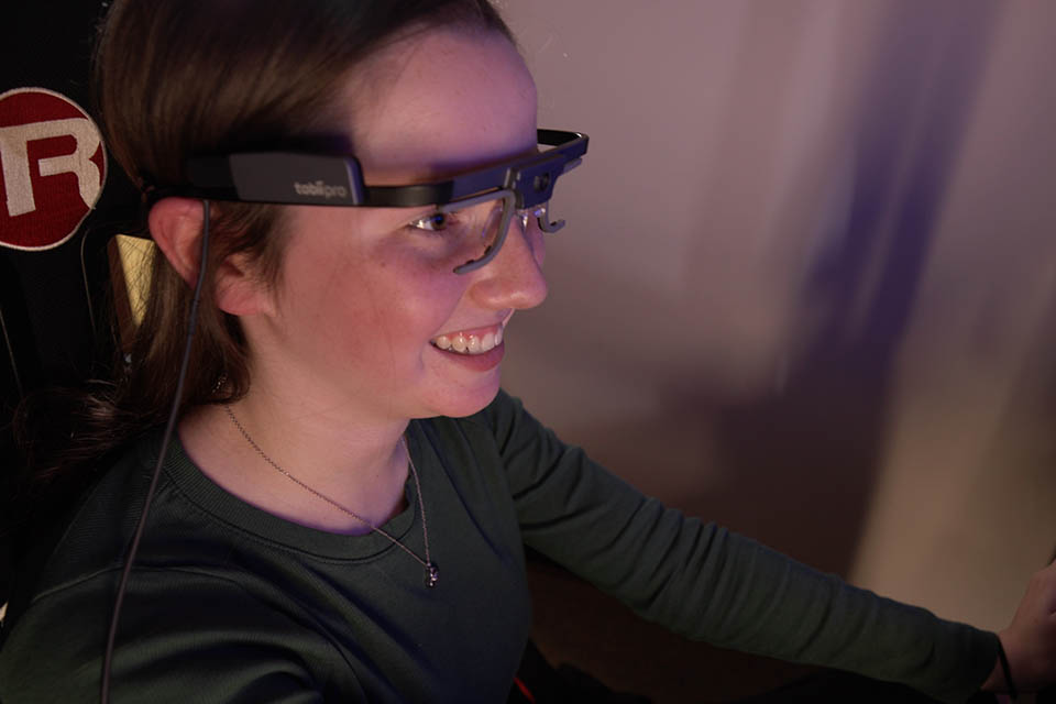 Teen wearing eye-tracking glasses worn by participants during driving simulation training and assessments. Teen wearing eye-tracking glasses worn by participants during driving simulation training and assessments.