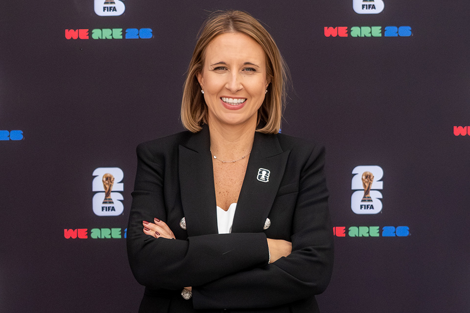 Amy Hopfinger in front of FIFA backdrop